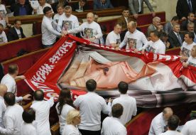 The deputies hold a poster with a picture of Yulia Tymoshenko