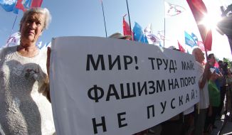 Participants of the anti-fascist meeting holding a poster