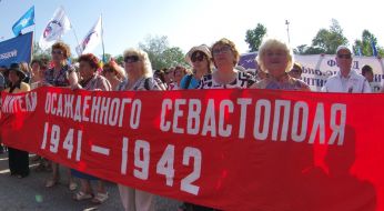 Participants of the anti-fascist meeting holding a poster