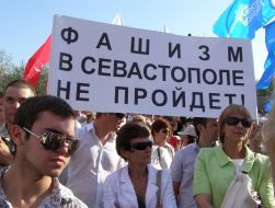 Participants of the anti-fascist meeting holding a poster