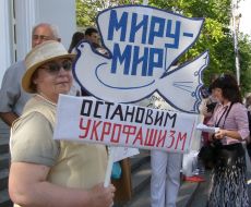 Participant of the anti-fascist meeting holding a poster