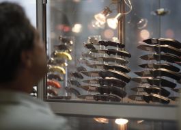 A man examines knives