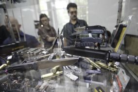 A men examine knives