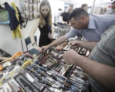 A man examines knives