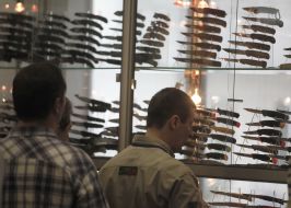 A men examine knives