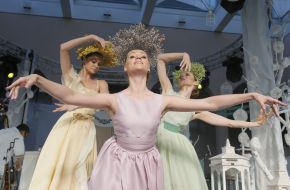 A model shows an evening dress