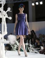 A model shows an evening dress