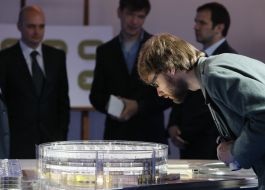 A man examines model of a sports and entertainment complex "Kiev-Arena"