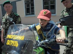 Schoolboy sitting at the border bike