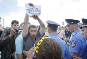 Police officers detain protesters