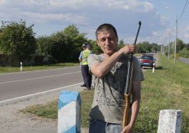 Participant of action with a gun near the border pillar