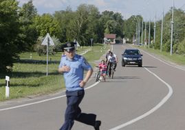 Police officer runs across the road