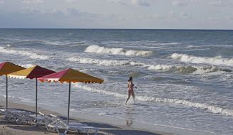 A girl walks into the sea