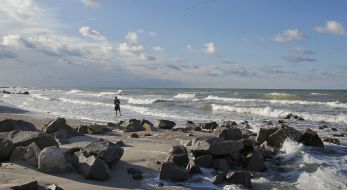 A girl walks into the sea