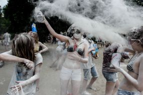 Young people sprinkle each other with flour