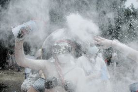 Young people sprinkle each other with flour