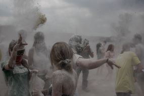 Young people sprinkle each other with flour
