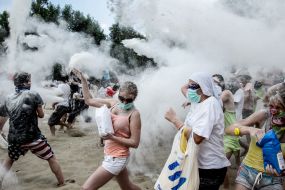 Young people sprinkle each other with flour
