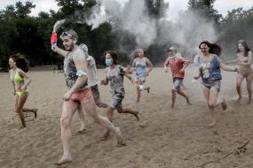 Young people sprinkle each other with flour