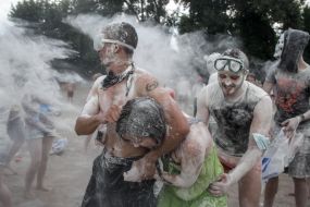 Young people sprinkle each other with flour