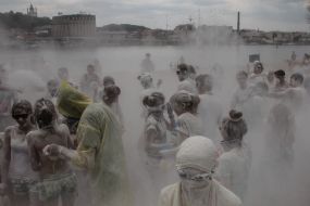 Young people sprinkle each other with flour