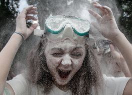 Young people sprinkle each other with flour