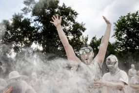 Young people sprinkle each other with flour