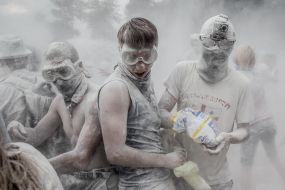 Young people sprinkle each other with flour
