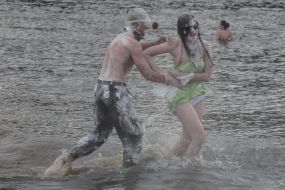 Young people sprinkle each other with flour