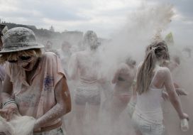 Young people sprinkle each other with flour