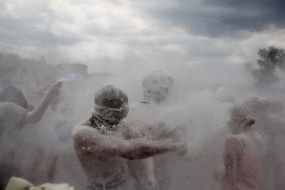 Young people sprinkle each other with flour