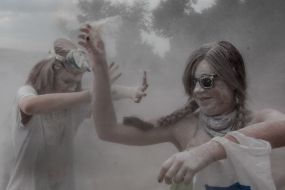 Young people sprinkle each other with flour