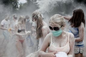 Young people sprinkle each other with flour