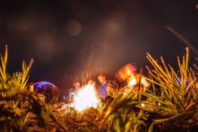 Girls jumping through a haystack