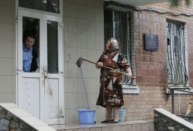 A woman washes door and wall police department