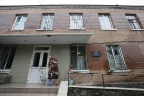 A woman washes door and wall police department
