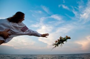 Girl puts a wreath on the water
