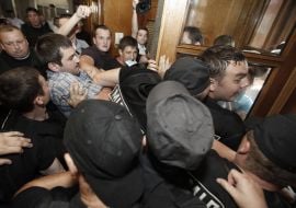 Participants of the protest try to get into the building KSCA