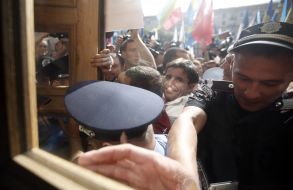 Participants of the protest try to get into the building KSCA