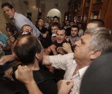 Participants of the protest try to get into the building KSCA