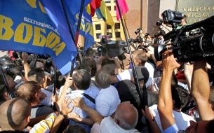 Participants of the protest try to get into the building KSCA