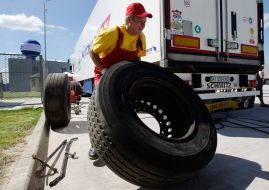 An employee changes the tire wheel