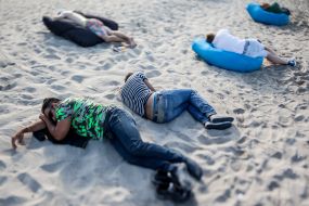 Young people rest on a beach