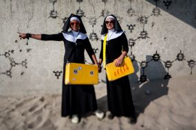 Young people in the suits of monks