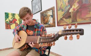 A musician plays on a bandura