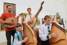 A musician plays on a bandura