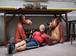 A man is taken pictures near sculptural composition