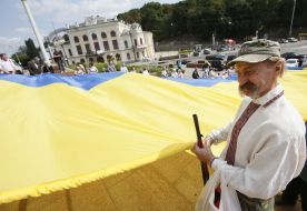The participants of action hold the enormous flag of Ukraine