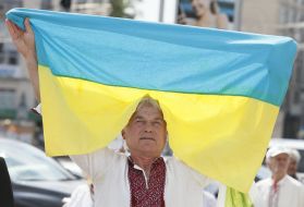 The participant of action holds the flag of Ukraine