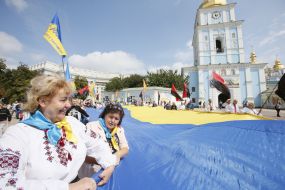 The participants of action hold the enormous flag of Ukraine
